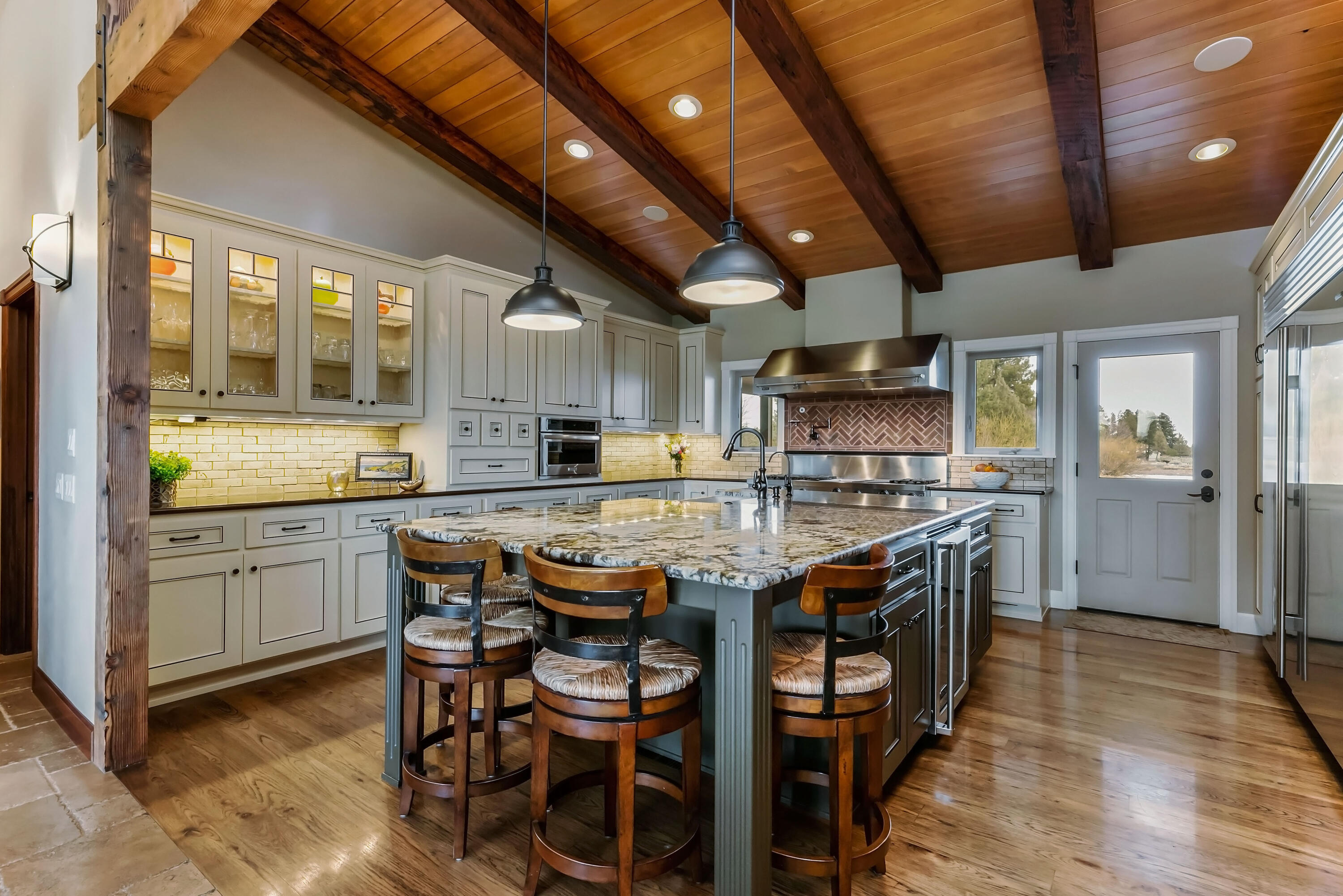 69015 Hurtley Ranch Road Sisters, OR 97759 - Photo 19 of 88 Gourmet chef's kitchen with view of pond and access to outdoor living area with fireplace and hot tub