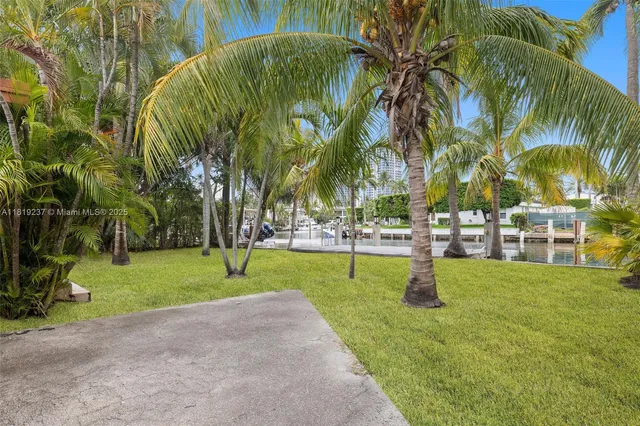 a swimming pool with outdoor seating and yard