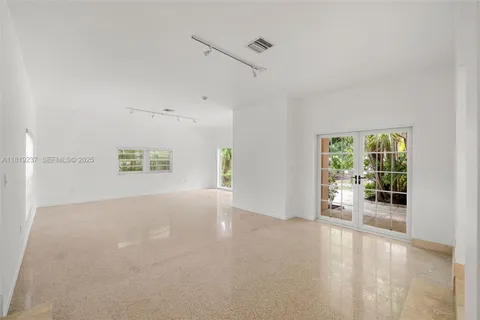 a view of a livingroom with wooden floor and a window