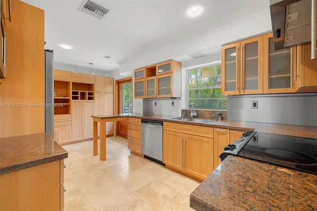 a kitchen with stainless steel appliances granite countertop a stove and a sink