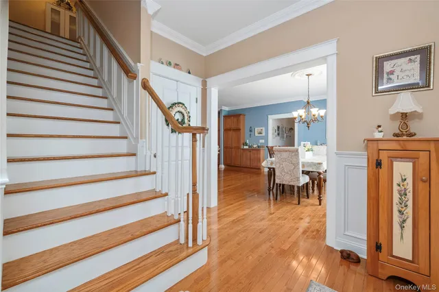 a view of a hallway with dining room and wooden floor