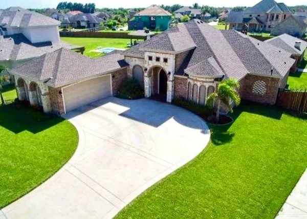 a view of a house with a garden and outdoor seating