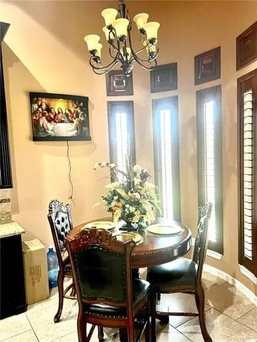 a view of a dining room with furniture and chandelier