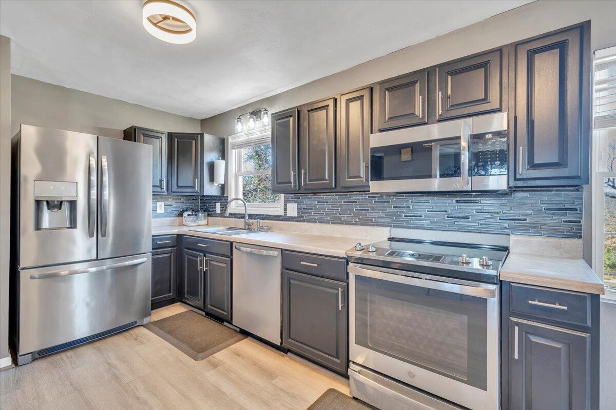 2624 Radford Road Northeast Roanoke, VA 24012 - Photo 11 of 55 a kitchen with granite countertop stainless steel appliances and wooden cabinets
