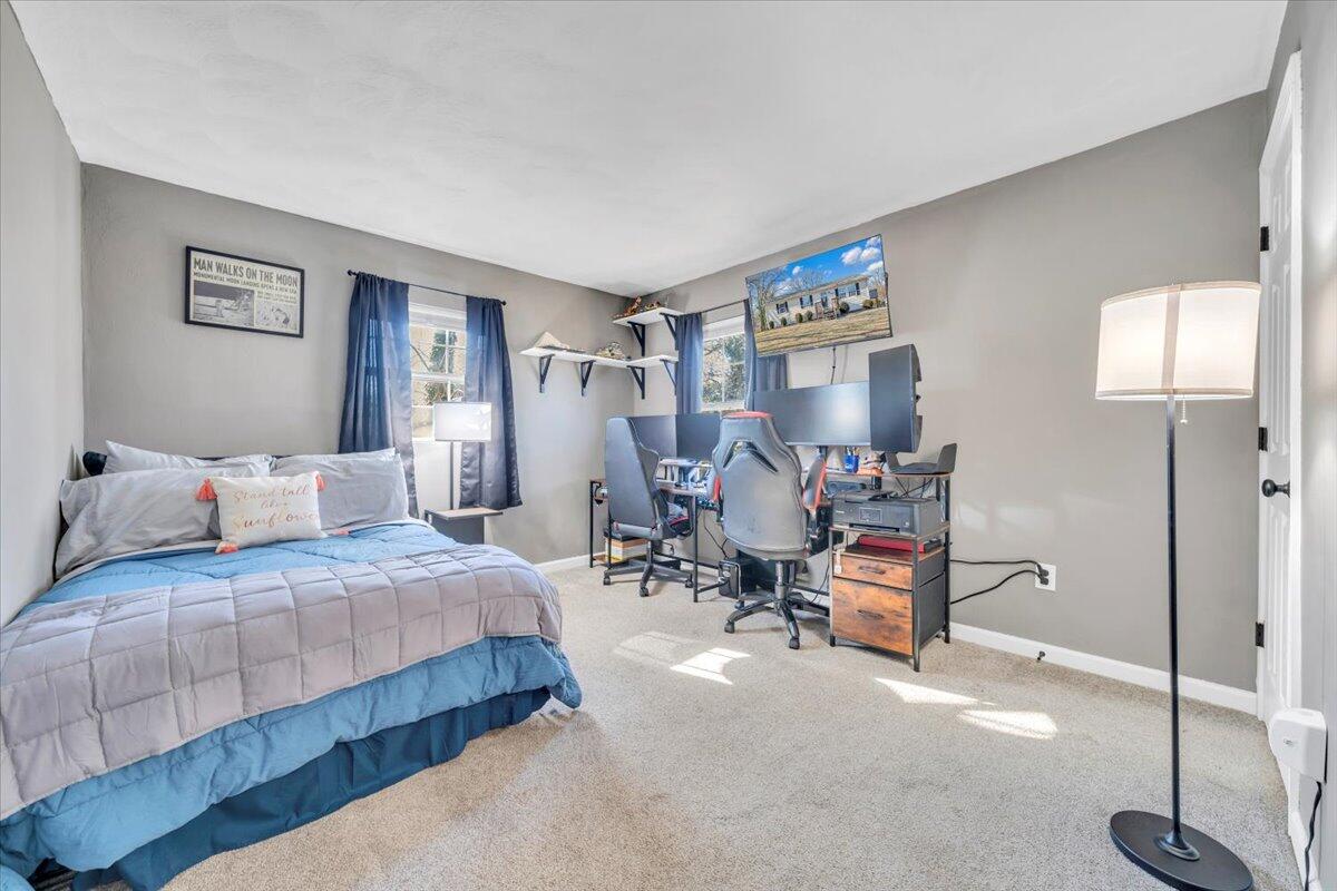 2624 Radford Road Northeast Roanoke, VA 24012 - Photo 12 of 55 a bedroom with a bed a table and chair