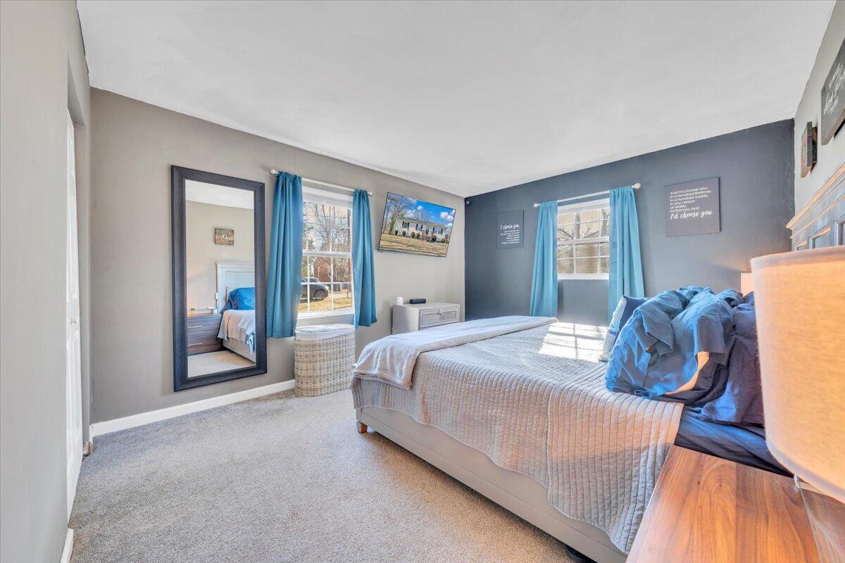 2624 Radford Road Northeast Roanoke, VA 24012 - Photo 16 of 55 a bedroom with a bed and large windows