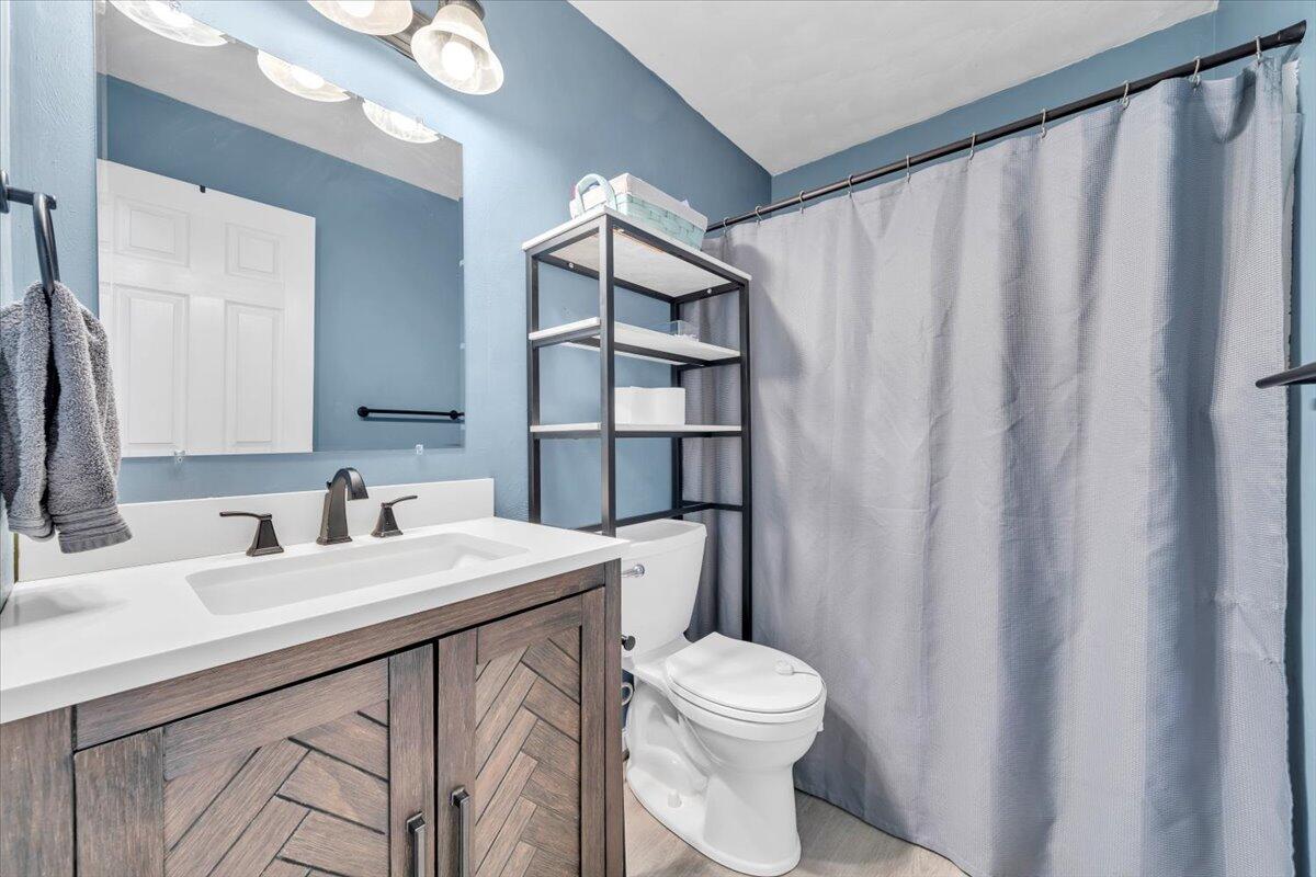 2624 Radford Road Northeast Roanoke, VA 24012 - Photo 21 of 55 a bathroom with a sink a toilet and shower curtain