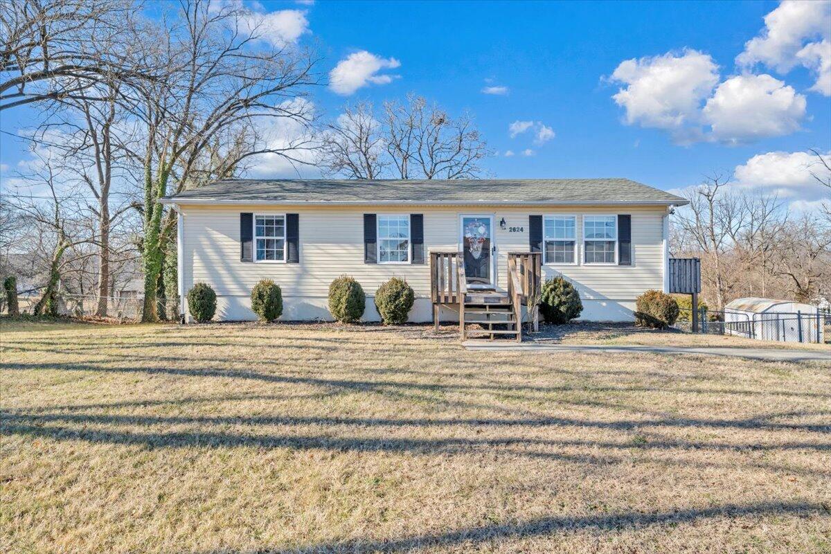 2624 Radford Road Northeast Roanoke, VA 24012 - Photo 35 of 55 a view of a house with a backyard and a tree