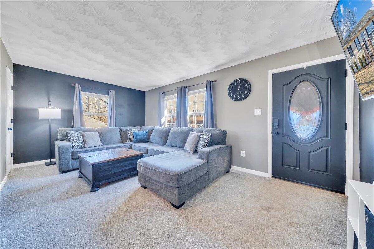 2624 Radford Road Northeast Roanoke, VA 24012 - Photo 4 of 55 a living room with couches a large mirror with wooden floor and windows
