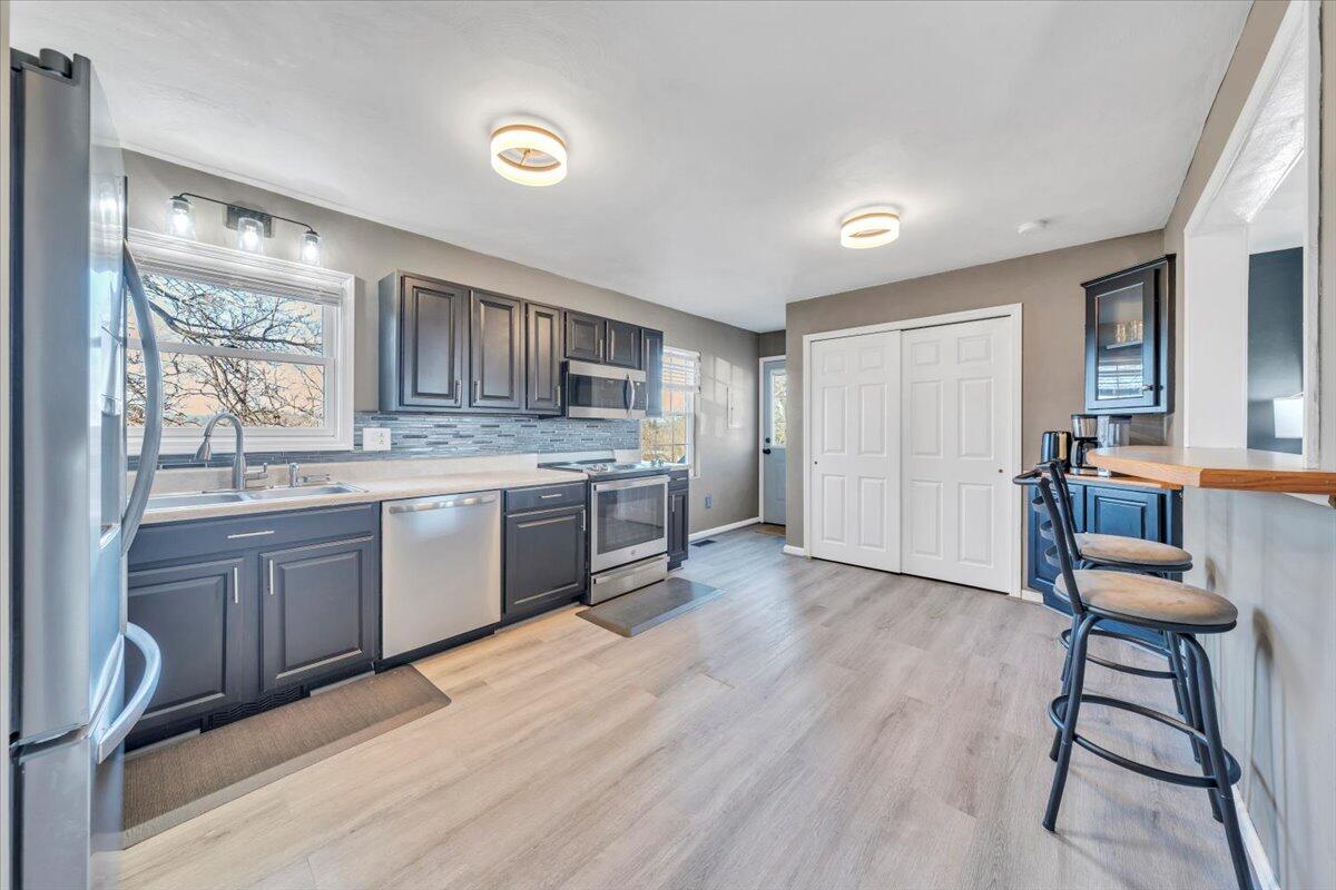 2624 Radford Road Northeast Roanoke, VA 24012 - Photo 7 of 55 a kitchen with a sink cabinets and wooden floor