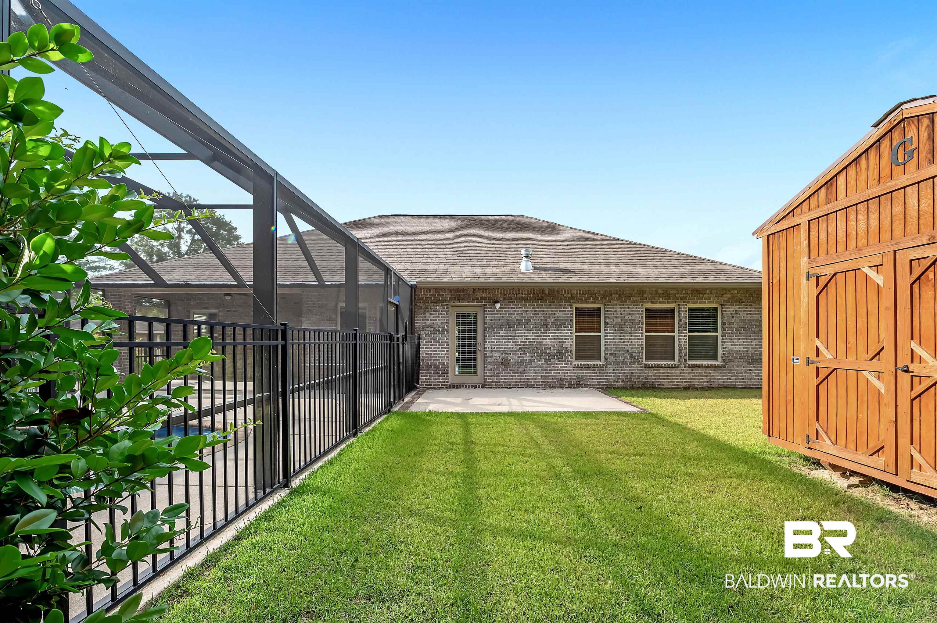 1086 Melbourne Court Foley, AL 36535 - Photo 36 of 43 View of yard featuring a lanai, a patio area, and a shed