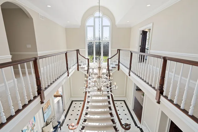 a view of a hallway with wooden floor and entryway