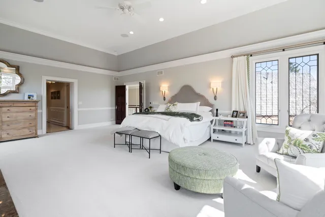 a bedroom with a bed and a large window