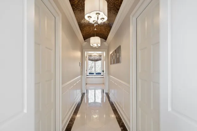 a spacious bedroom with a bed and a chandelier
