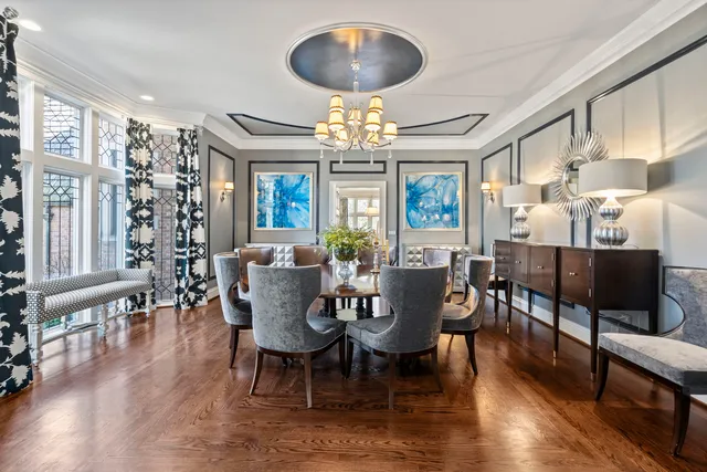 an open kitchen with wooden floor and stainless steel appliances