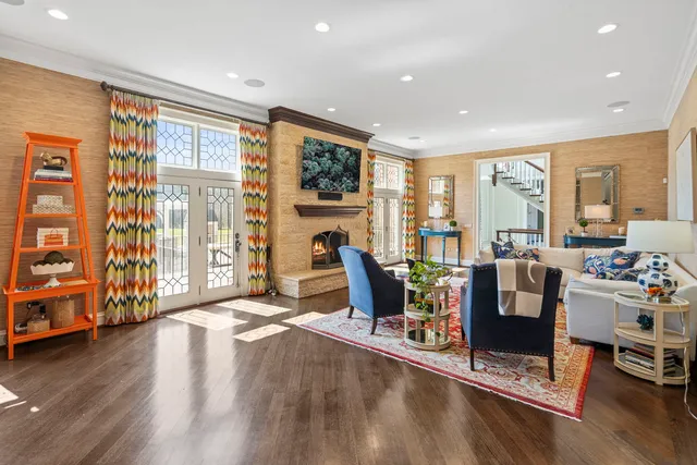 a living room with furniture and a chandelier