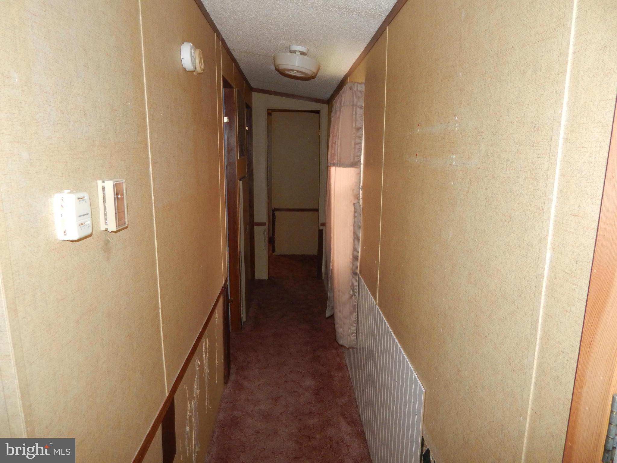 189 Washington Street Inwood, WV 25428 - Photo 14 of 30 a view of a hallway with wooden floor