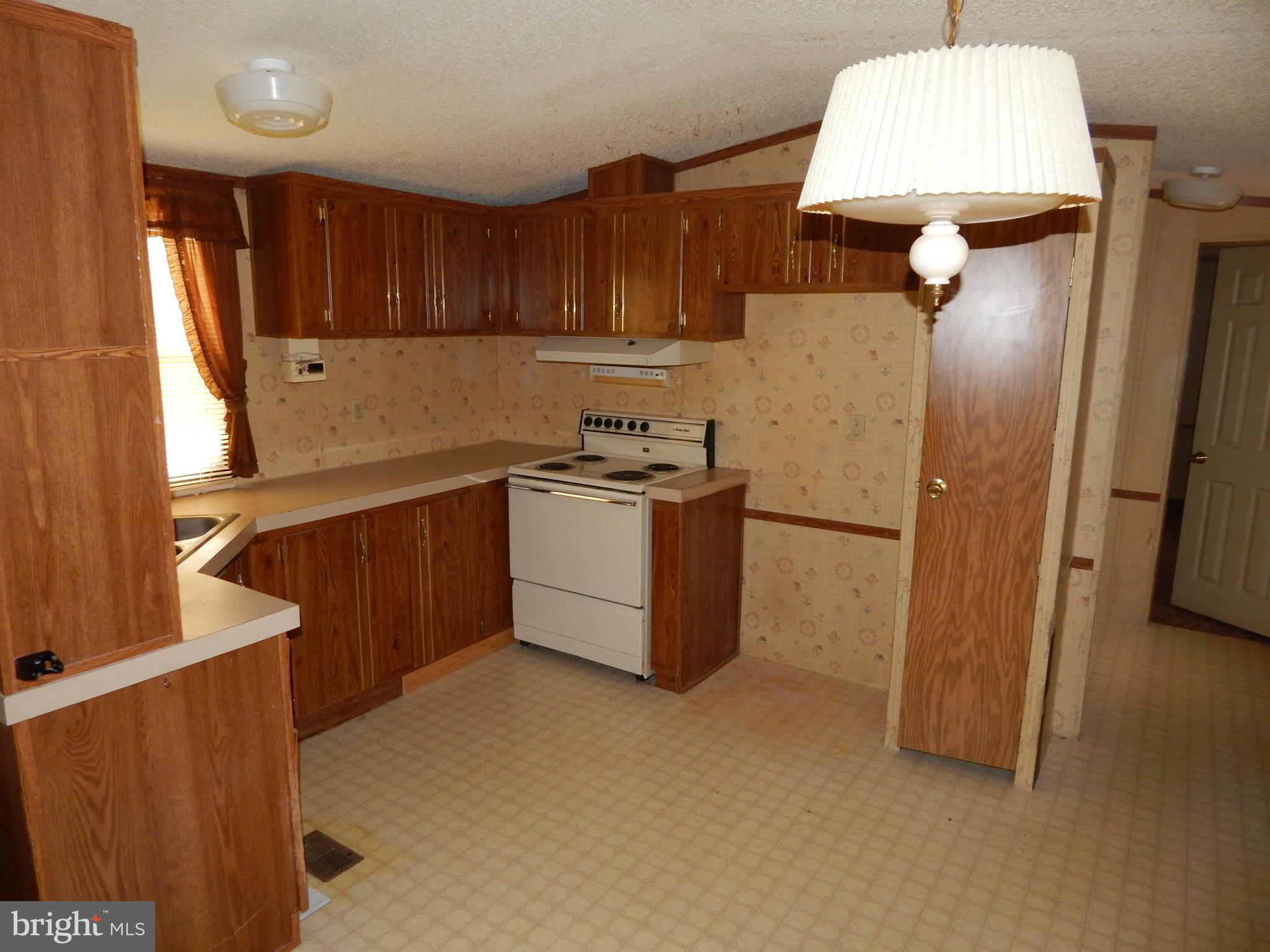 189 Washington Street Inwood, WV 25428 - Photo 4 of 30 a kitchen with stainless steel appliances granite countertop a sink stove and refrigerator
