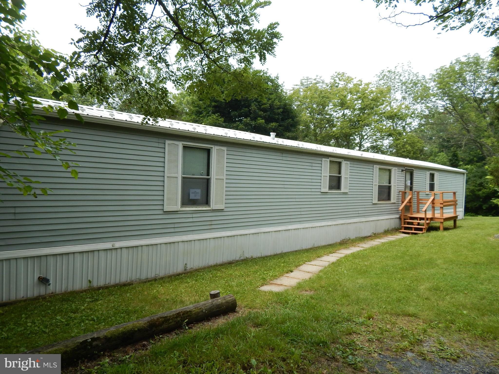 189 Washington Street Inwood, WV 25428 - Photo 6 of 30 a view of a backyard with plants and a large tree