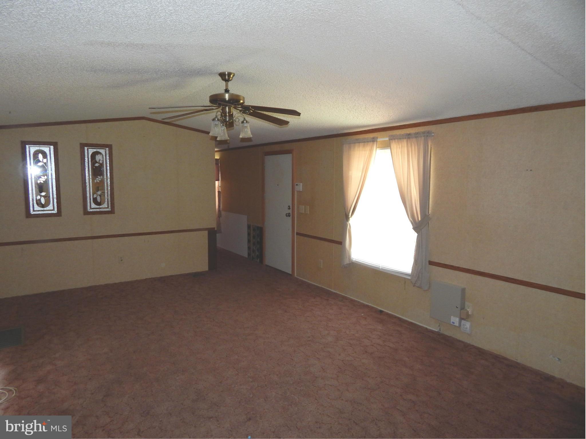 189 Washington Street Inwood, WV 25428 - Photo 8 of 30 an empty room with windows and fan