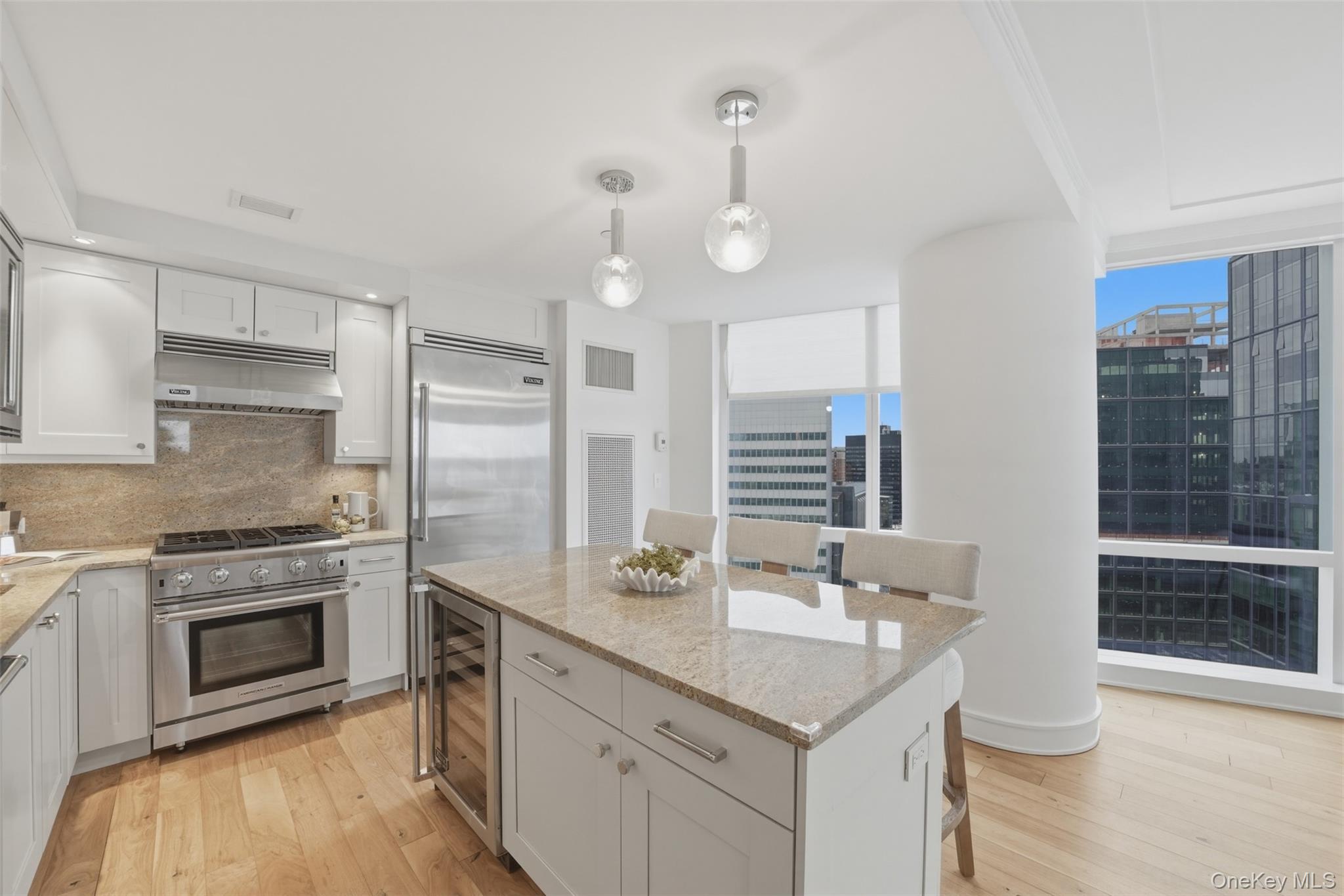 5 Renaissance Square, Unit 16D White Plains, NY 10601 - Photo 11 of 36 a kitchen with a sink dishwasher a stove and a refrigerator with wooden floor