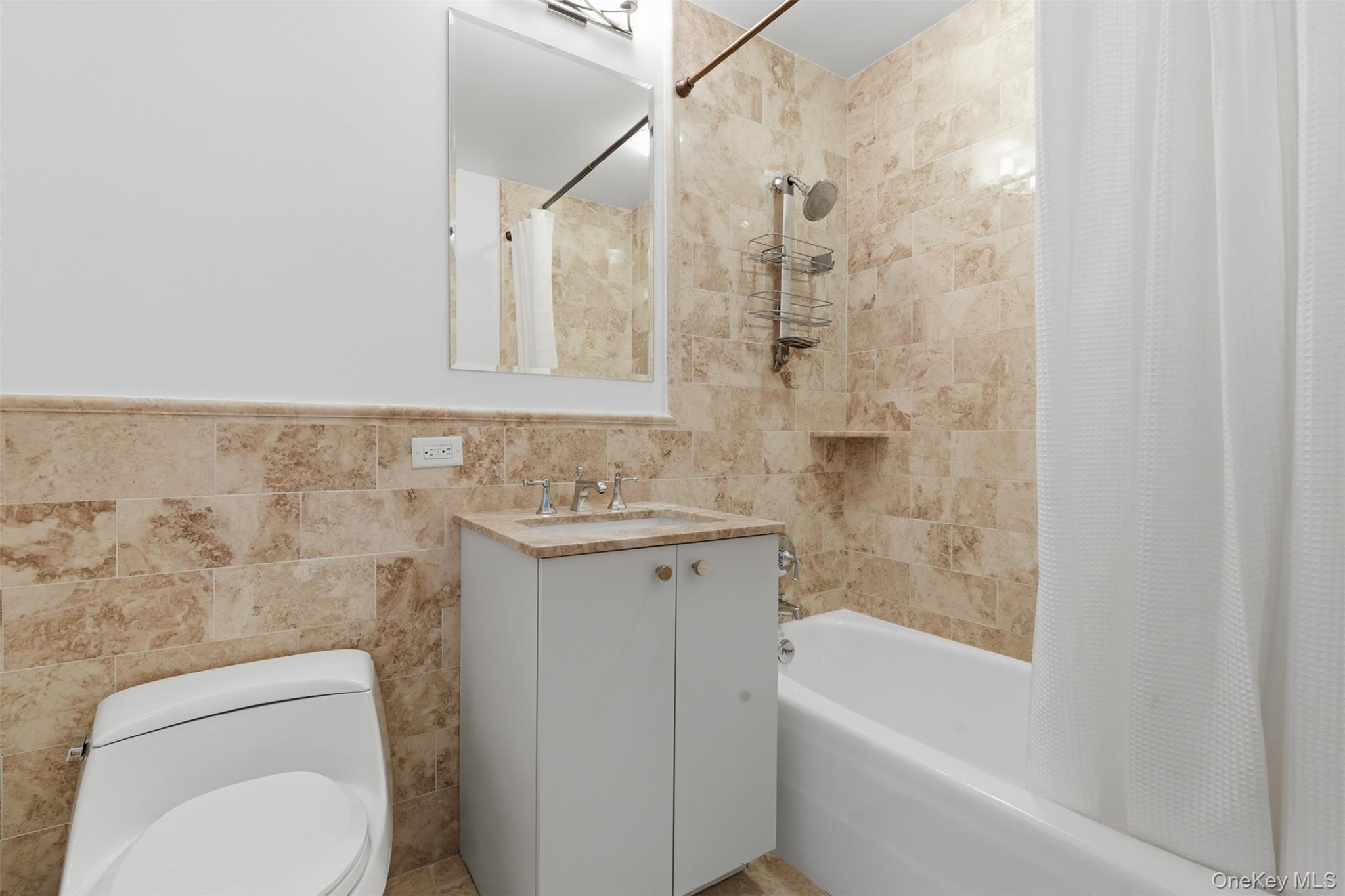 5 Renaissance Square, Unit 16D White Plains, NY 10601 - Photo 13 of 29 a bathroom with a granite countertop toilet a sink and bathtub