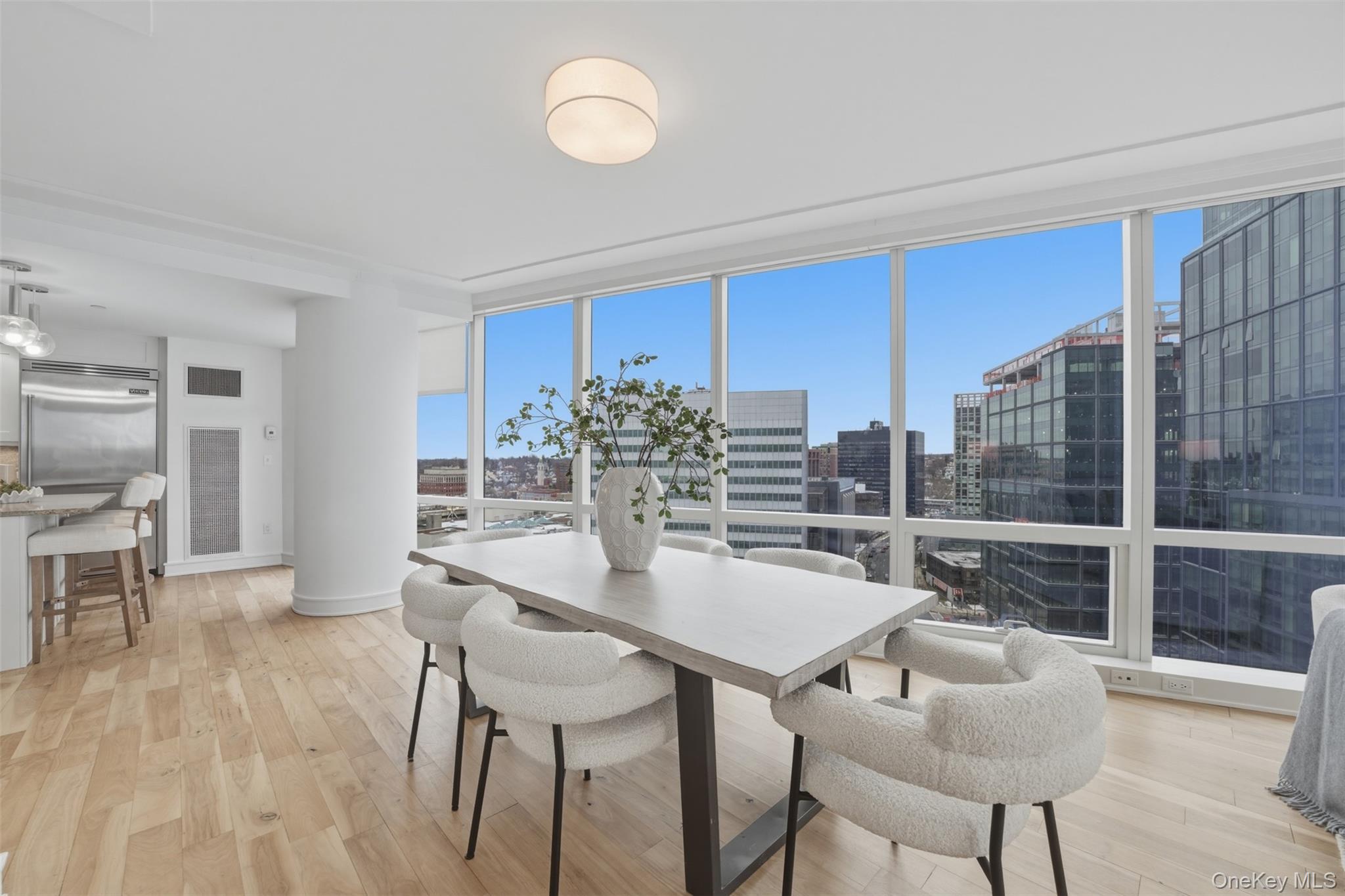 5 Renaissance Square, Unit 16D White Plains, NY 10601 - Photo 14 of 36 a dining room with furniture and wooden floor