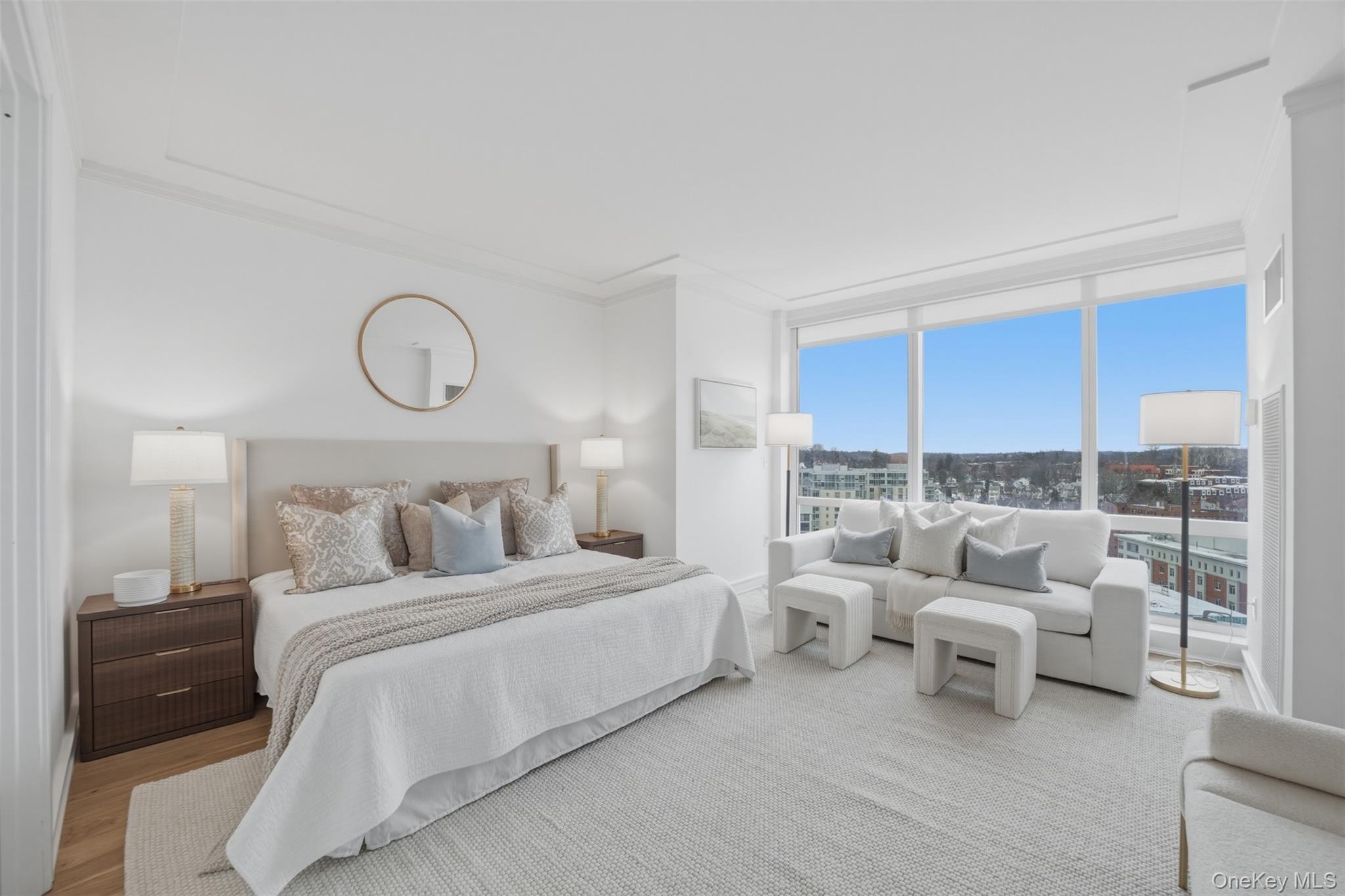 5 Renaissance Square, Unit 16D White Plains, NY 10601 - Photo 15 of 36 a bedroom with a bed and a couch