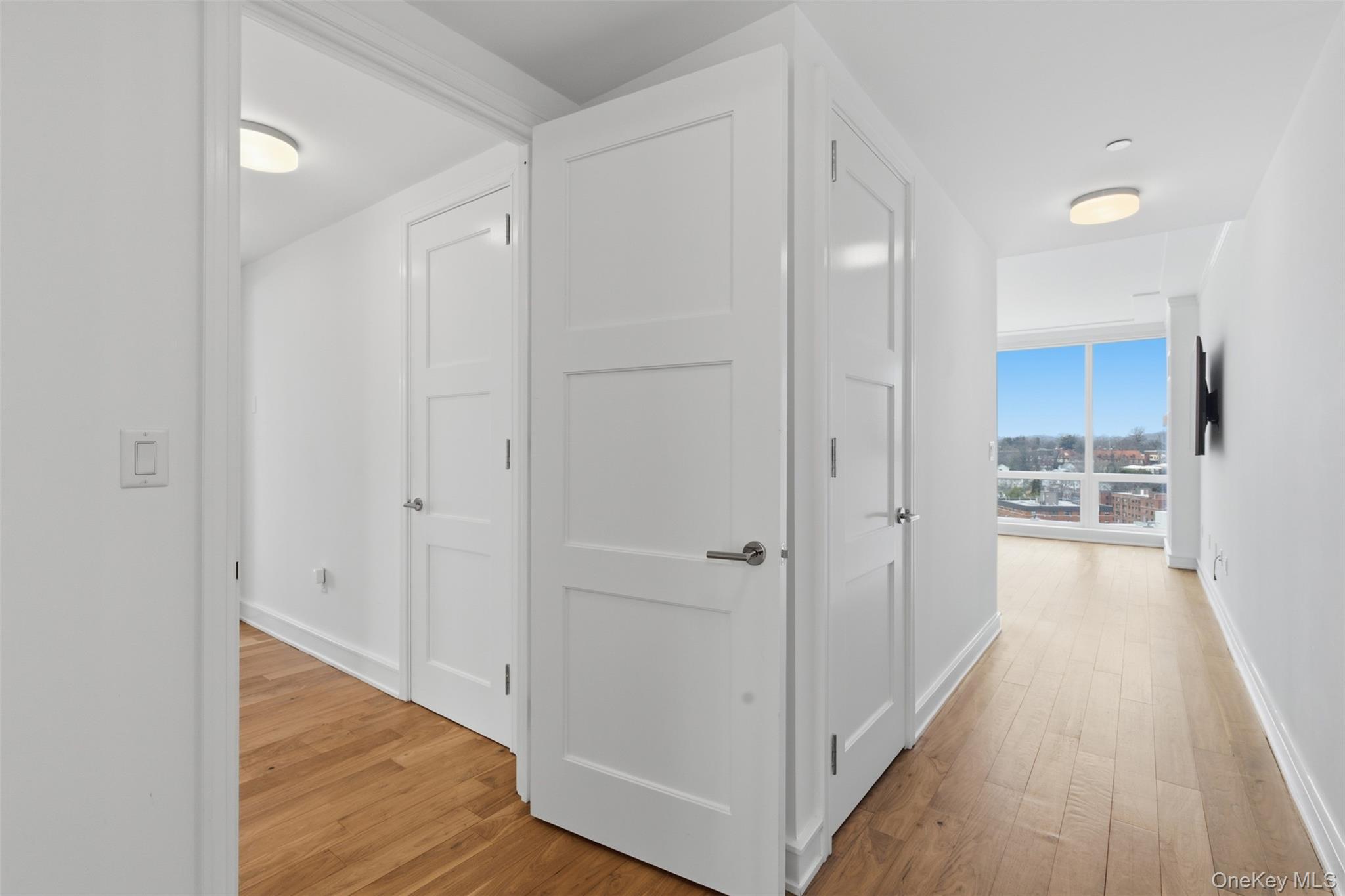 5 Renaissance Square, Unit 16D White Plains, NY 10601 - Photo 15 of 29 a view of a hallway with wooden floor