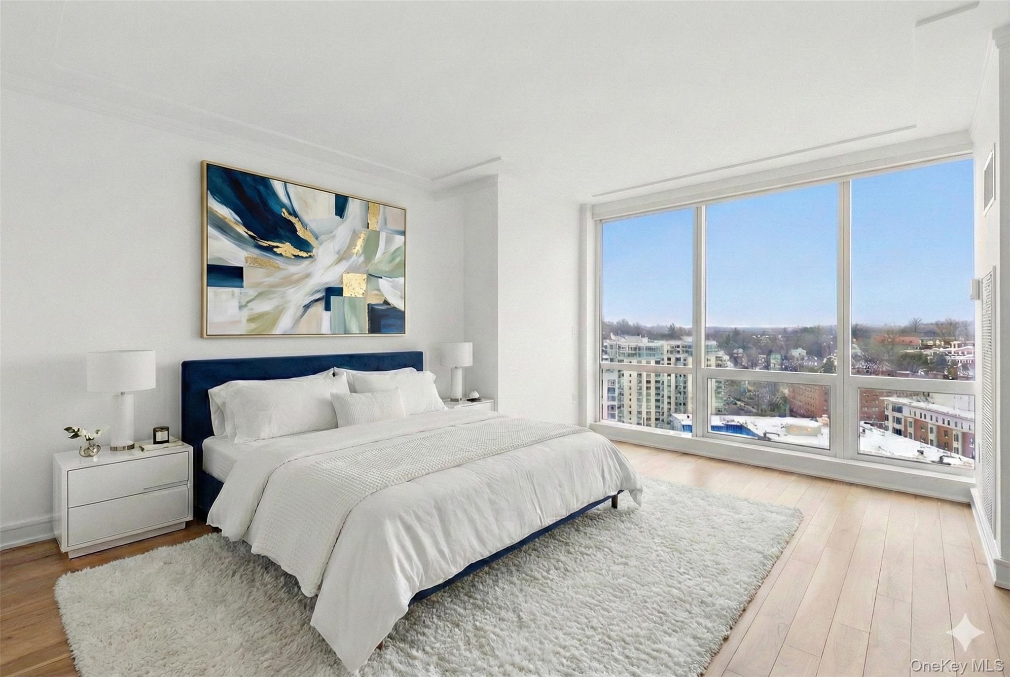 5 Renaissance Square, Unit 16D White Plains, NY 10601 - Photo 17 of 29 a bedroom with a bed and glass walk in closet