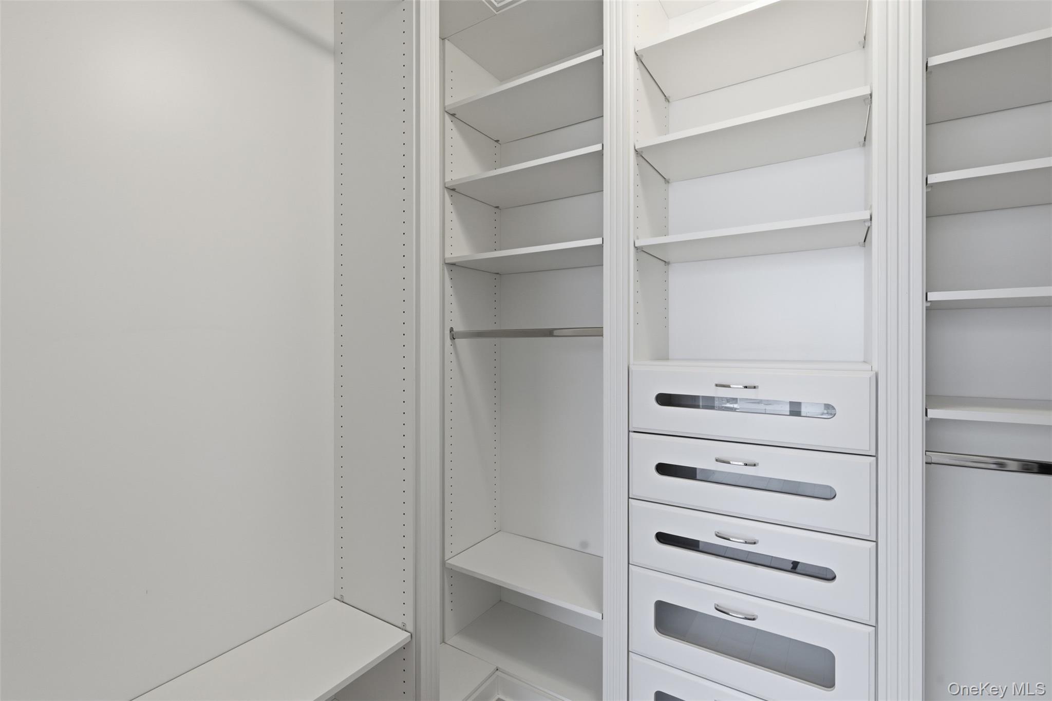 5 Renaissance Square, Unit 16D White Plains, NY 10601 - Photo 18 of 29 a walk in closet with white paint