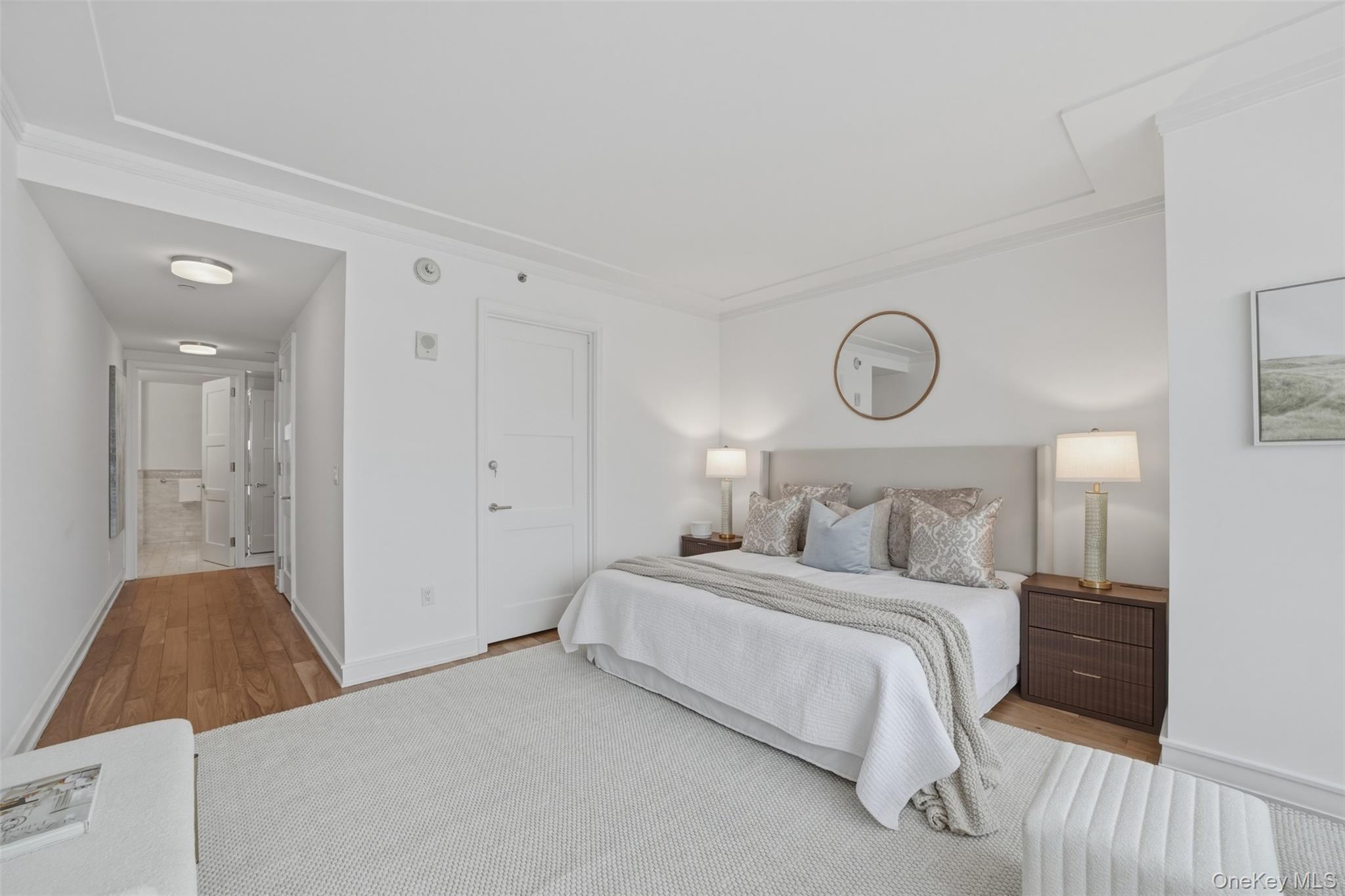 5 Renaissance Square, Unit 16D White Plains, NY 10601 - Photo 18 of 36 a bedroom with a bed and a lamp