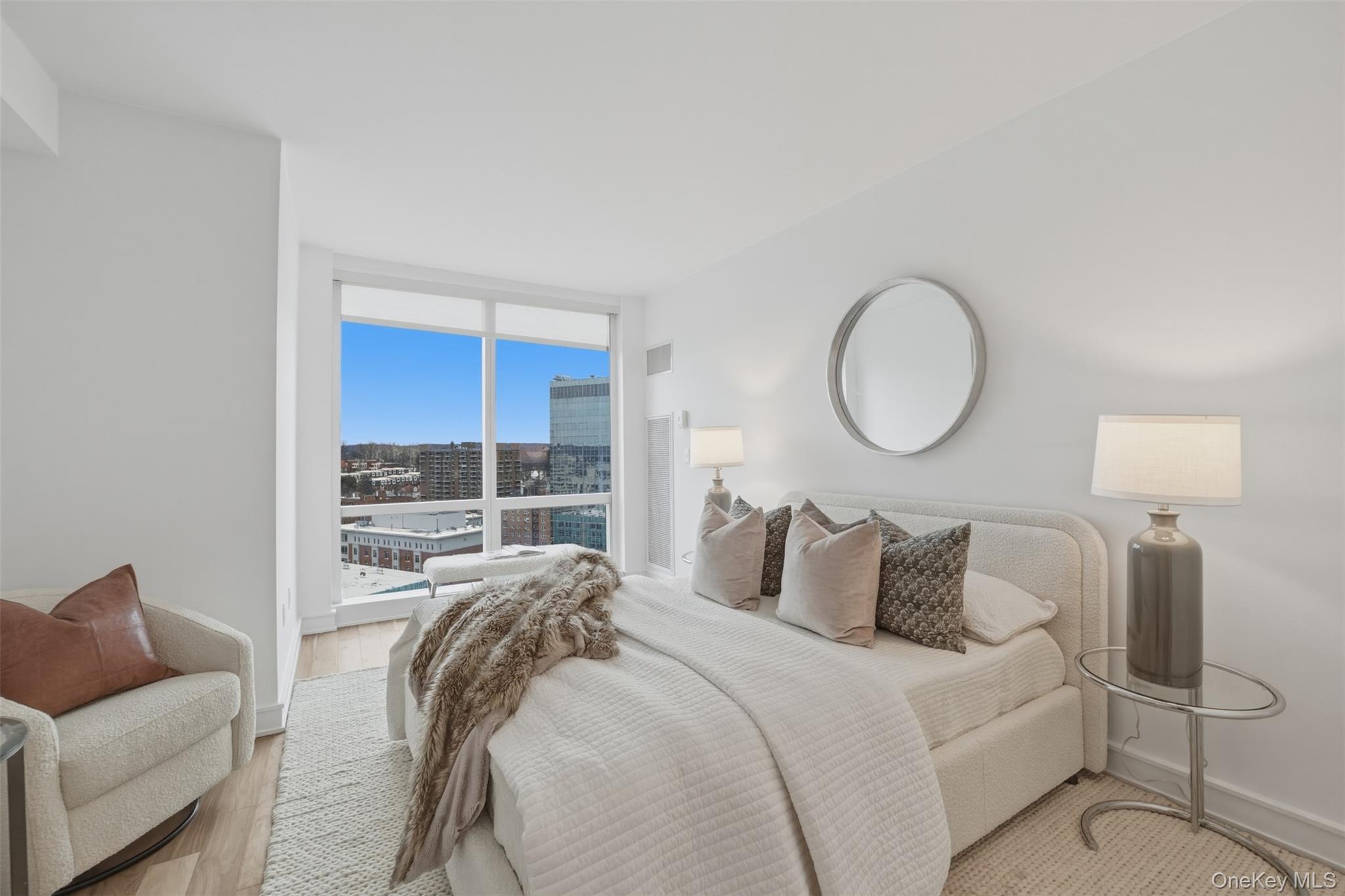 5 Renaissance Square, Unit 16D White Plains, NY 10601 - Photo 20 of 36 a bedroom with a bed and lamp