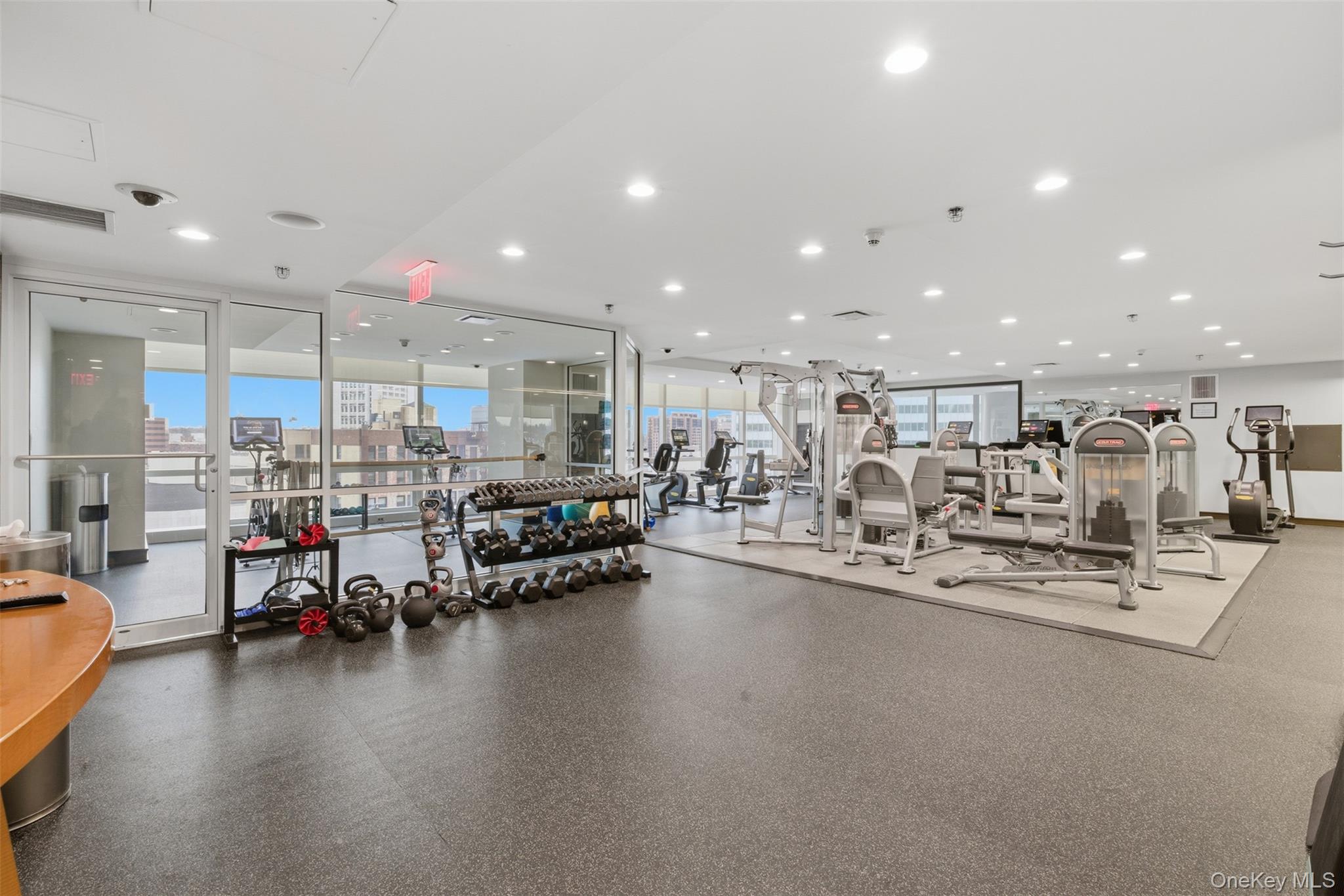5 Renaissance Square, Unit 16D White Plains, NY 10601 - Photo 21 of 29 a living room with lots of furniture and a flat screen tv