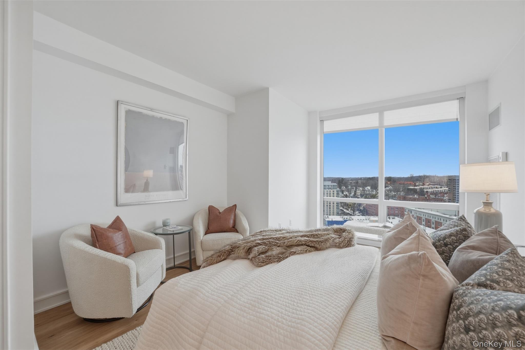 5 Renaissance Square, Unit 16D White Plains, NY 10601 - Photo 21 of 36 a bedroom with furniture and a window