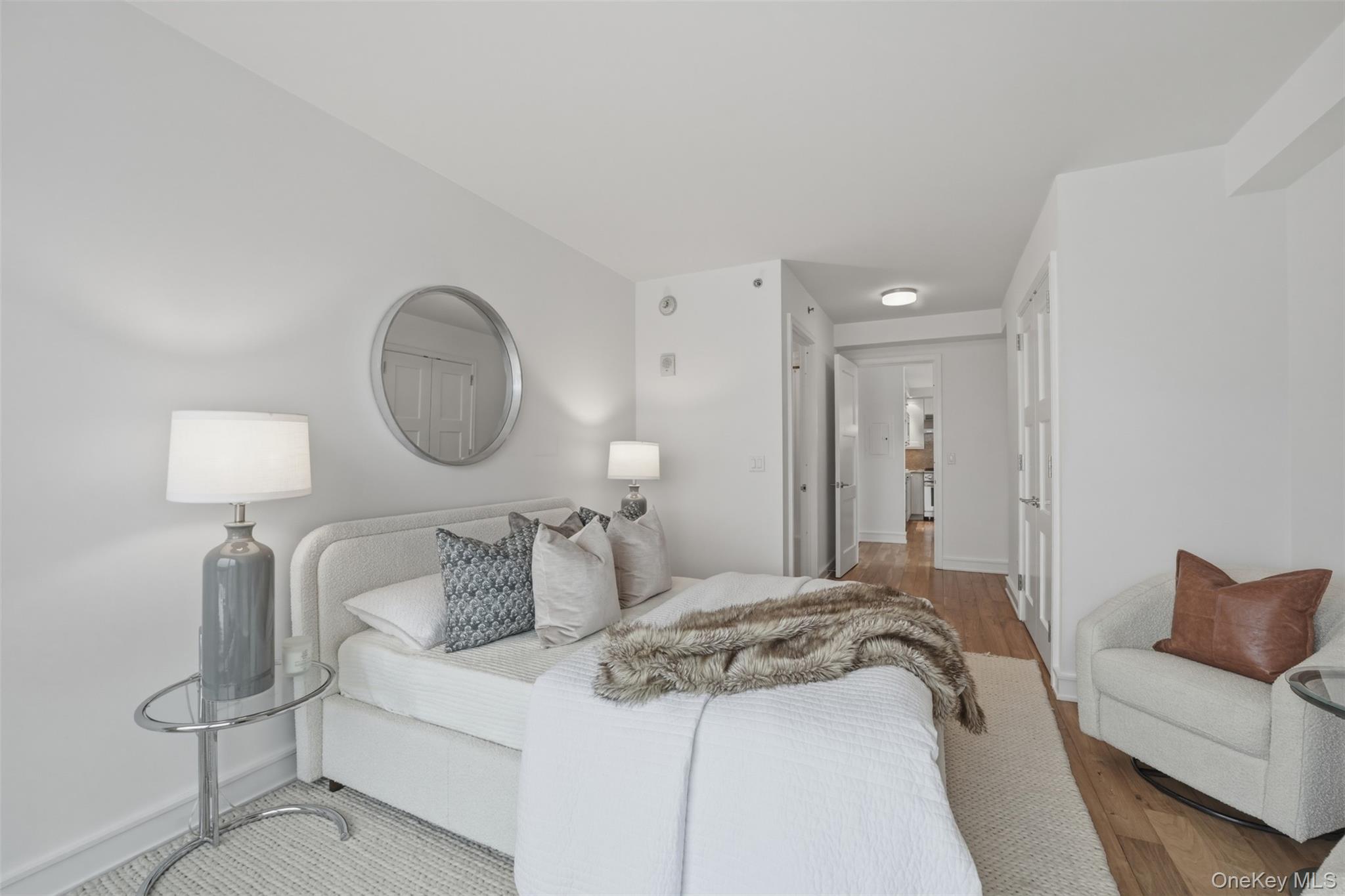 5 Renaissance Square, Unit 16D White Plains, NY 10601 - Photo 22 of 36 a bedroom with a bed and a lamp
