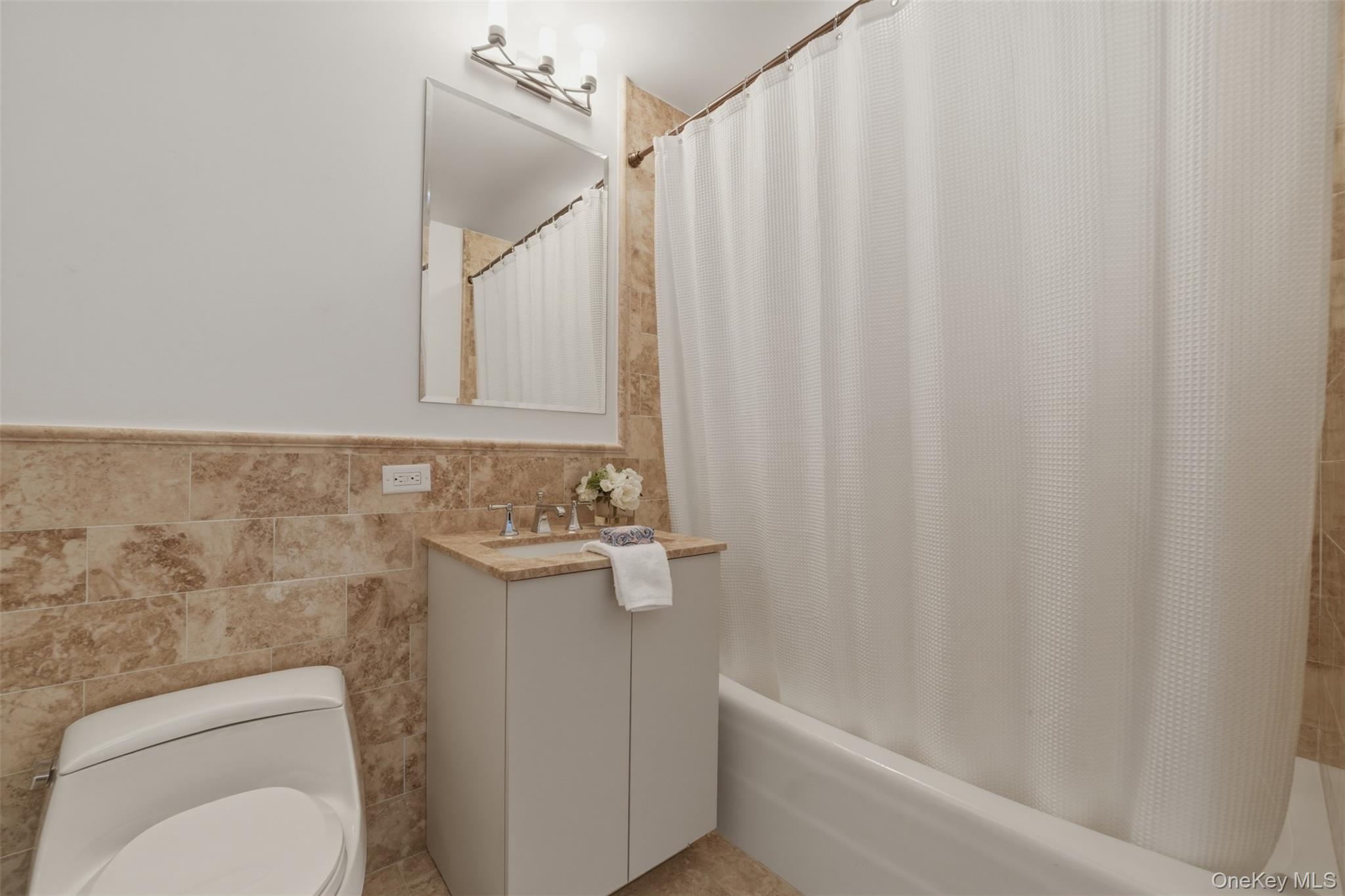 5 Renaissance Square, Unit 16D White Plains, NY 10601 - Photo 23 of 36 a bathroom with a toilet a sink and bathtub