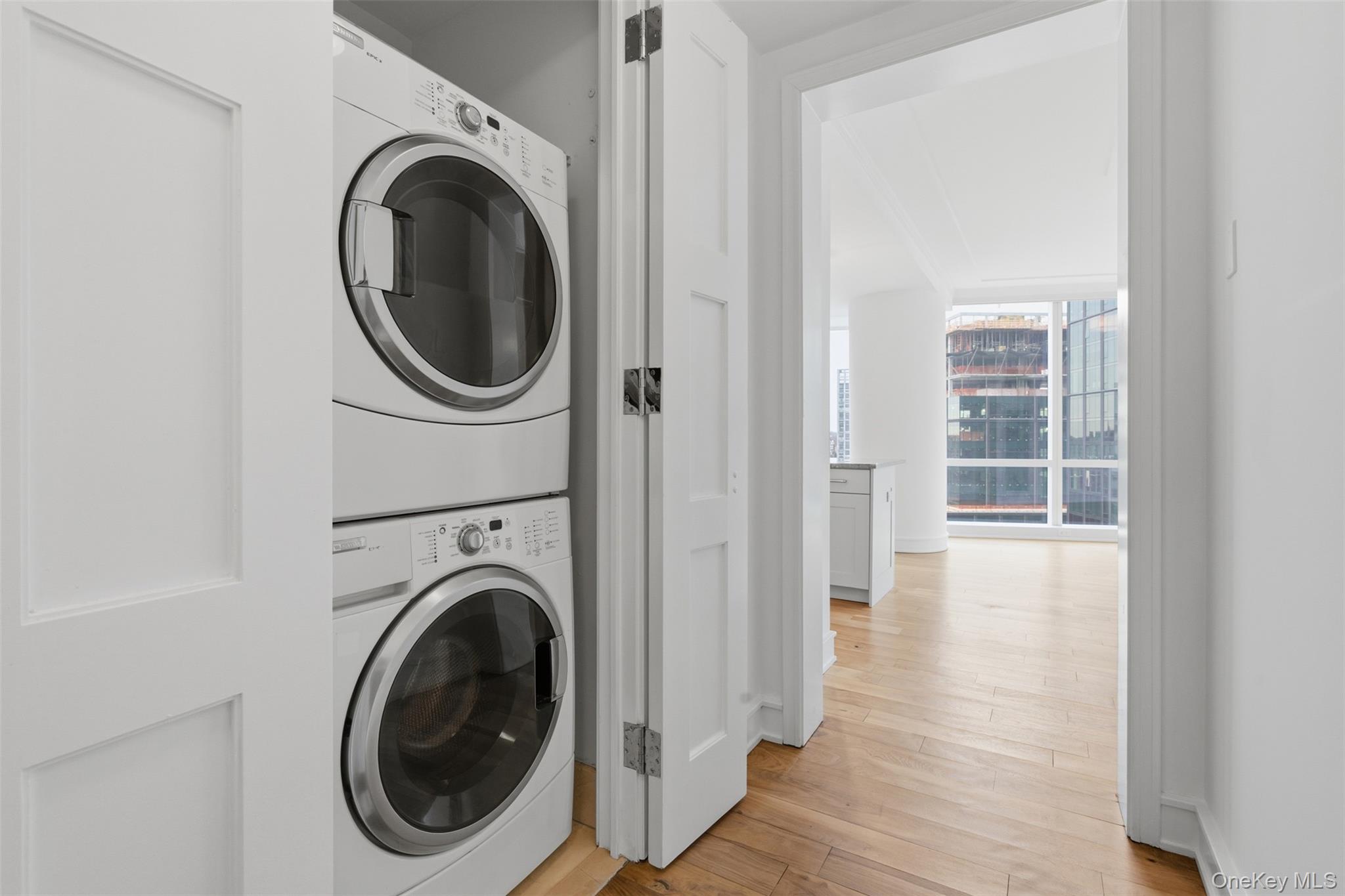 5 Renaissance Square, Unit 16D White Plains, NY 10601 - Photo 24 of 36 a view of a hallway with washer and dryer