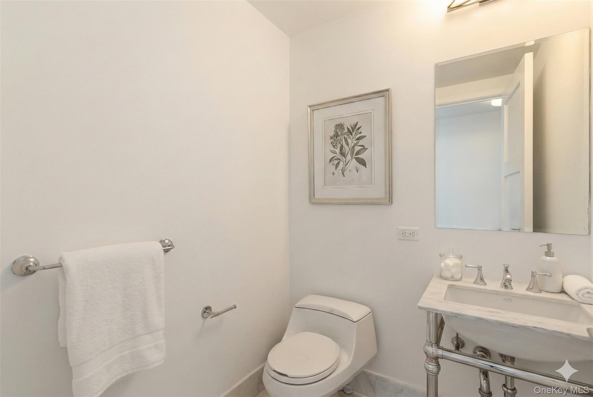 5 Renaissance Square, Unit 16D White Plains, NY 10601 - Photo 5 of 29 a white toilet sitting next to a bathroom sink