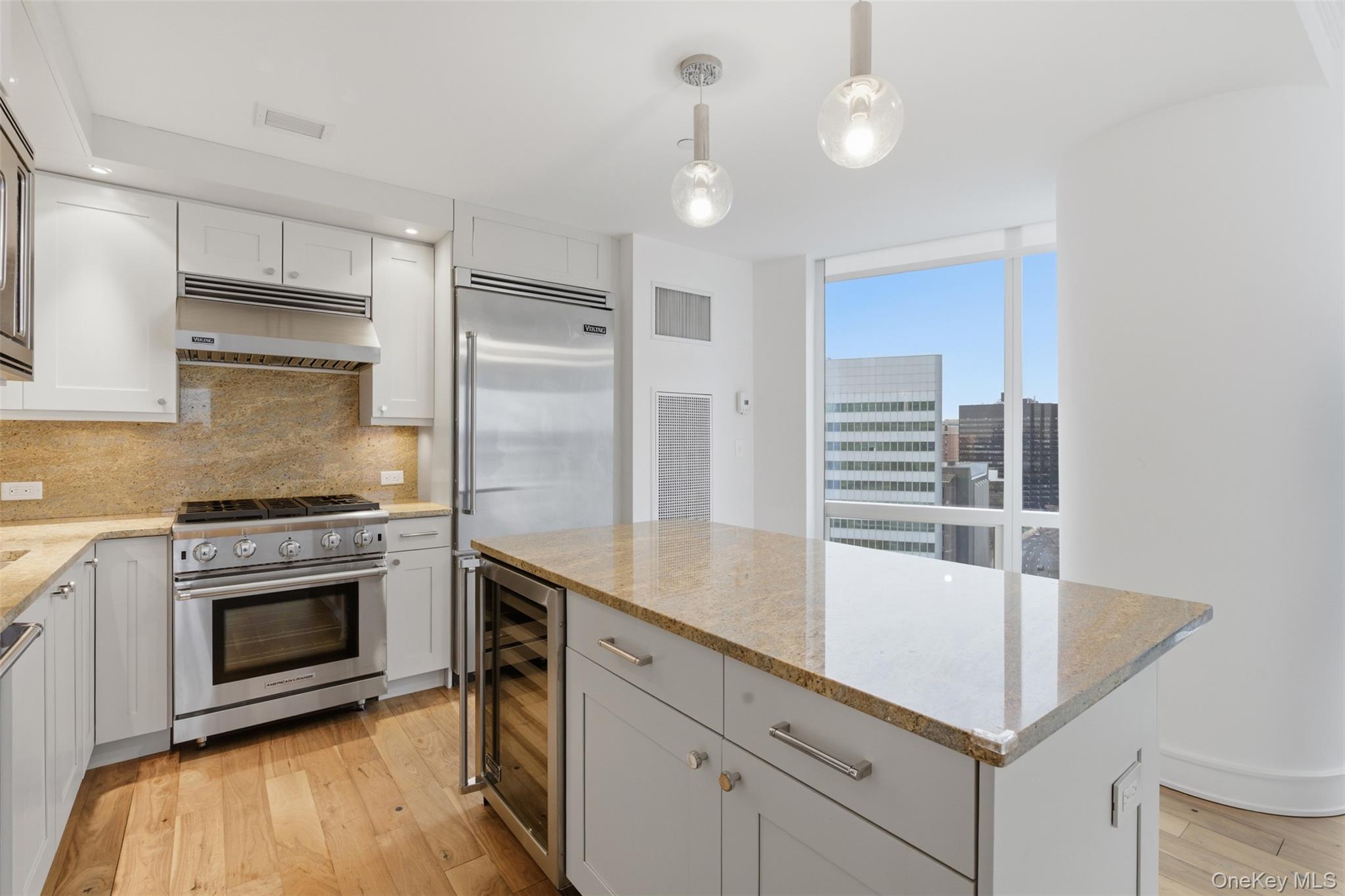5 Renaissance Square, Unit 16D White Plains, NY 10601 - Photo 6 of 29 a kitchen with cabinets and stainless steel appliances