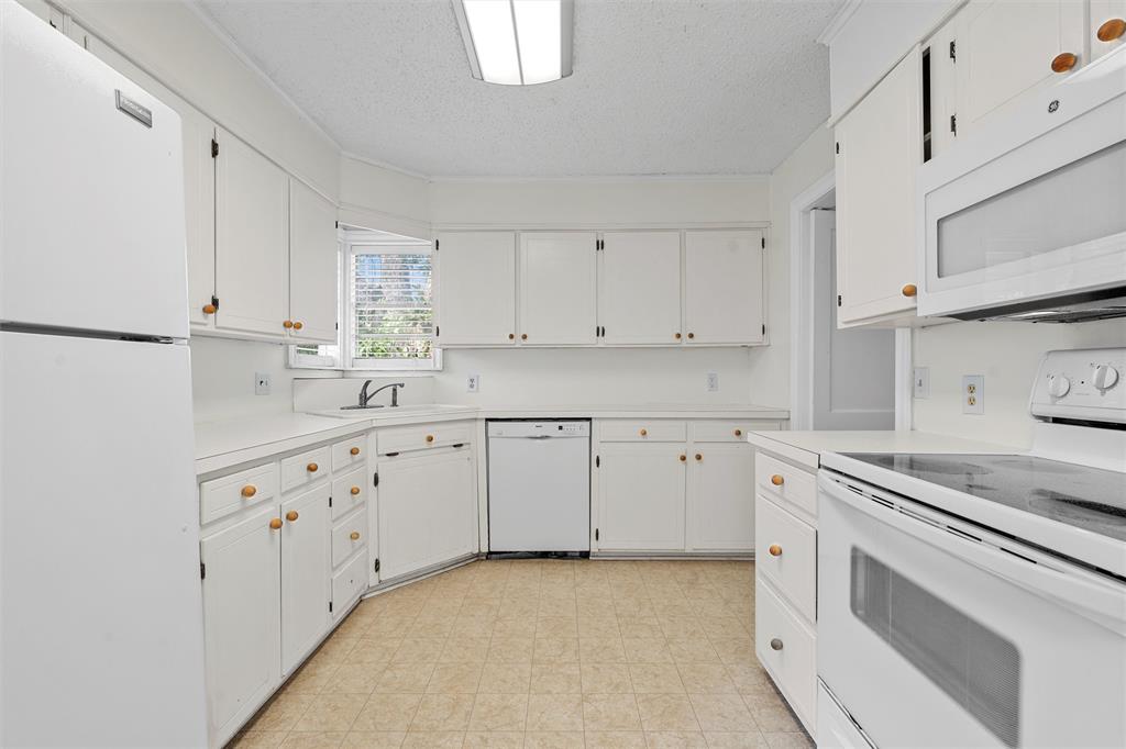 2601 Proctor Avenue Waco, TX 76708 - Photo 11 of 28 a kitchen with granite countertop white cabinets and white appliances