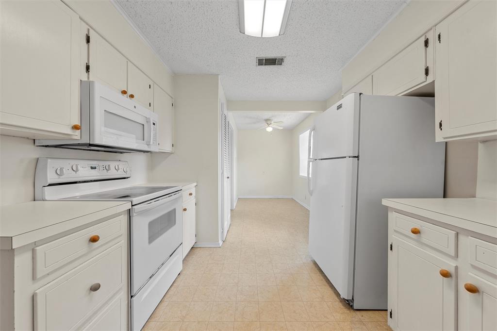 2601 Proctor Avenue Waco, TX 76708 - Photo 12 of 28 a kitchen with cabinets appliances a sink and a counter top space