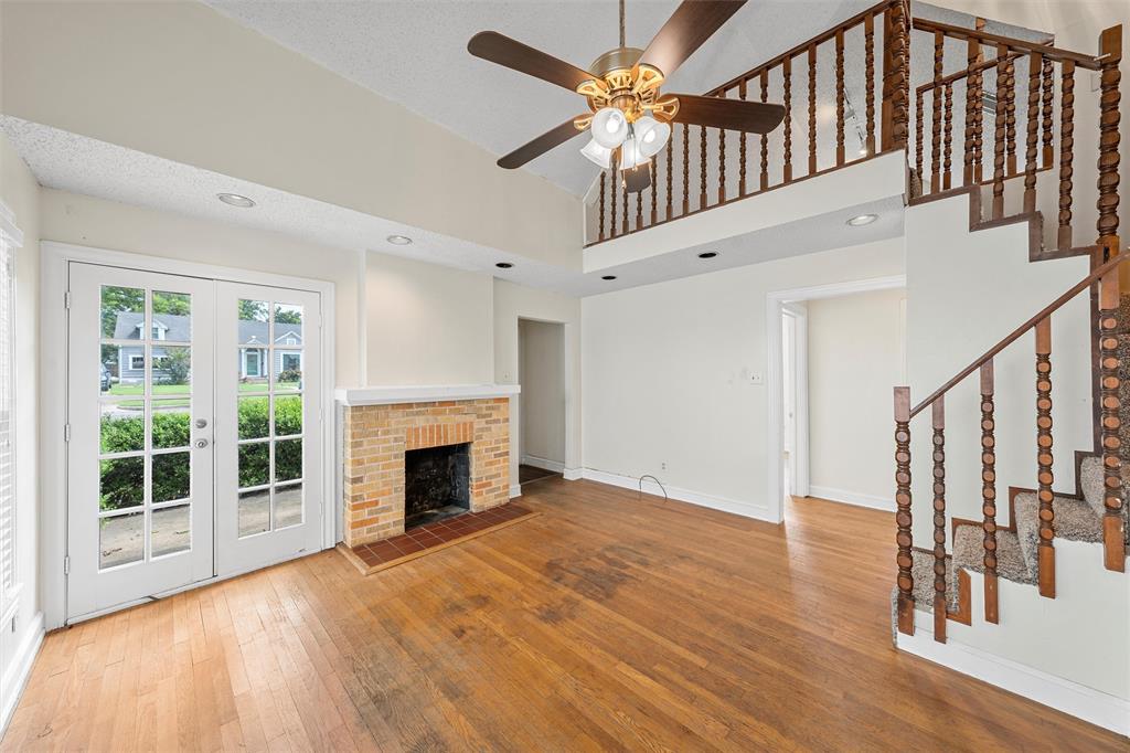 2601 Proctor Avenue Waco, TX 76708 - Photo 5 of 28 a view of an empty room with wooden floor fireplace and a window