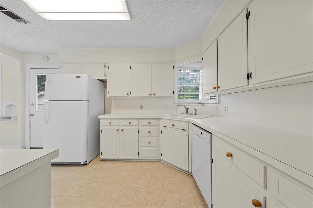 2601 Proctor Avenue Waco, TX 76708 - Photo 10 of 28 a kitchen with cabinets appliances a sink and a counter space