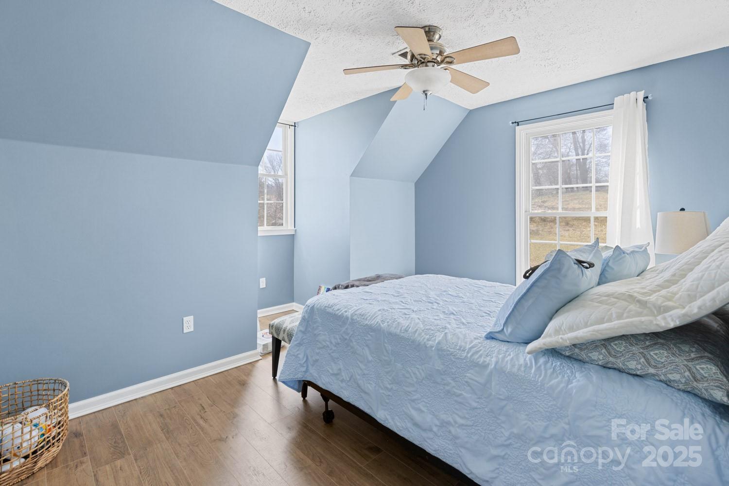 122 Ramsey Road Asheville, NC 28806 - Photo 12 of 19 a bedroom with a bed and wooden floor