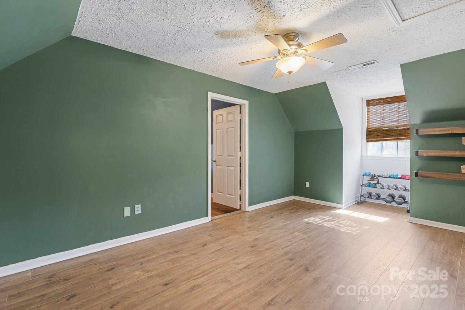 122 Ramsey Road Asheville, NC 28806 - Photo 13 of 19 a view of a room with a ceiling fan and hardwood floor