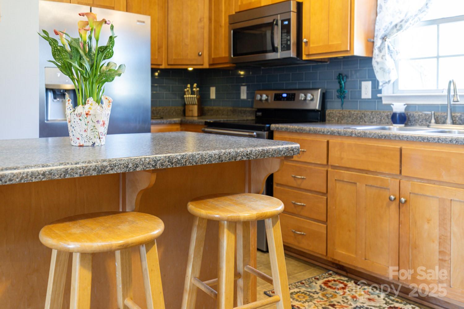122 Ramsey Road Asheville, NC 28806 - Photo 8 of 19 a kitchen with stainless steel appliances granite countertop a sink a microwave cabinets and a dining table