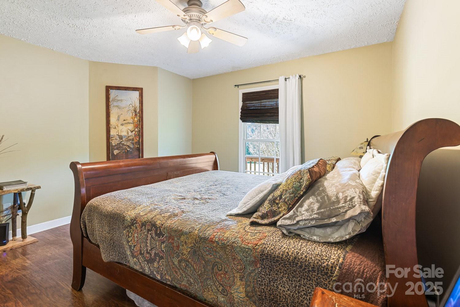 122 Ramsey Road Asheville, NC 28806 - Photo 9 of 19 a bedroom with a bed and a tv