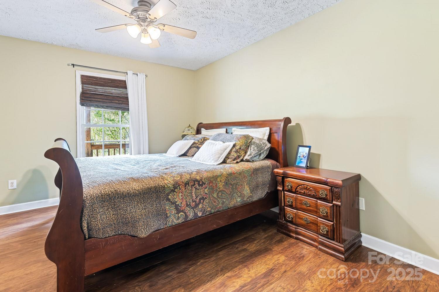 122 Ramsey Road Asheville, NC 28806 - Photo 10 of 19 a bedroom with a bed and window