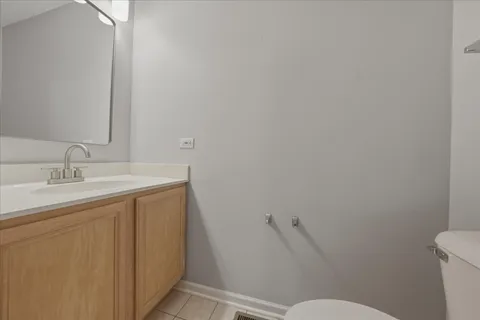 a bathroom with a sink mirror vanity and toilet